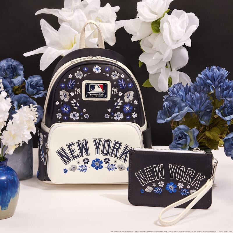 Blue and white floral Loungefly New York Yankees mini backpack and wristlet wallet against a blue and navy background and surrounded by blue and white flowers
